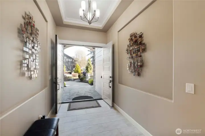 The view from the inside looking out to the water feature invites peaceful vibes as you enter this home.