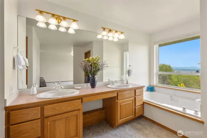 Primary Bathroom with double vanity and a relaxing soaking tub...that looks out to the stunning views!