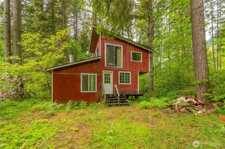 Recreational cabin on 10 AC in Randle, WA with a White Pass address. Top floor has the one bedroom, below the bedroom is the kitchen and to the left is the living room. There is a front door, back door and slider off the living room.