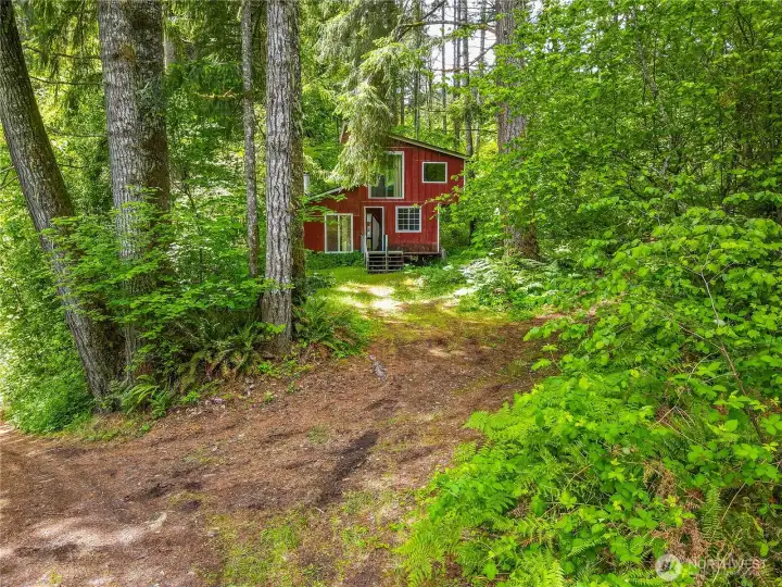 Cabin sits back off street.