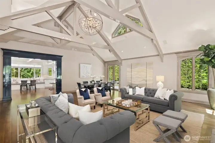 An open, flowing layout effortlessly transitions from the living area into the formal dining space and chef’s kitchen beyond. Highlighted by the continuous vaulted ceilings and painted beams, this vantage point captures the true "great room" essence of the home, perfect for seamless entertaining. An open, flowing layout effortlessly transitions from the living area into the formal dining space and chef’s kitchen beyond. Highlighted by the continuous vaulted ceilings and painted beams, this vantage point captures the true "great room" essence of the home, perfect for seamless entertaining.