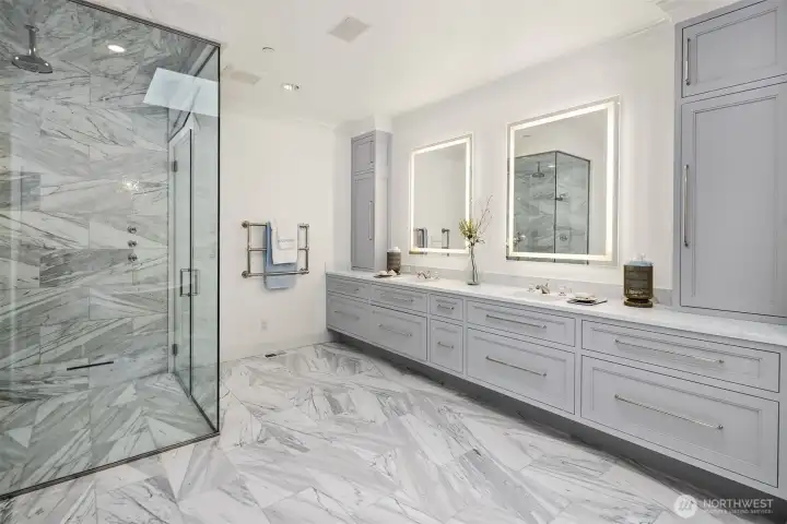 Indulge in a spa-like retreat within the gorgeously remodeled primary bathroom. This luxurious sanctuary features radiant heated marble tile flooring, an expansive walk-in steam shower enclosed in premium stone, a heated towel bar for ultimate comfort, and a stunning Waterworks soaking tub perfect for unwinding. A massive dual-sink vanity with custom cabinetry offers abundant storage and sleek modern finishes. Indulge in a spa-like retreat within the gorgeously remodeled primary bathroom. This luxurious sanctuary features radiant heated marble tile flooring, an expansive walk-in steam shower enclosed in premium stone, a heated towel bar for ultimate comfort, and a stunning Waterworks soaking tub perfect for unwinding. A massive dual-sink vanity with custom cabinetry offers abundant storage and sleek modern finishes.