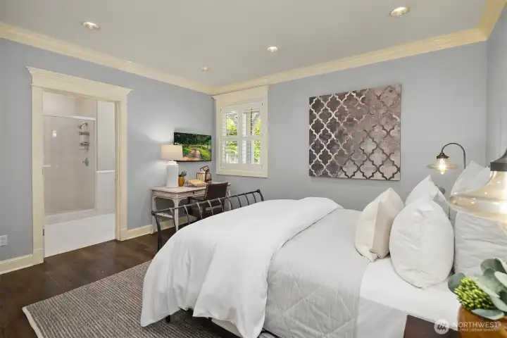 A coveted main floor guest bedroom offers a private, serene retreat for visitors. This light-filled ensuite features elegant crown molding, a bright window overlooking the patio, and its own dedicated 3/4 bathroom, ensuring absolute comfort and privacy on the main level. A coveted main floor guest bedroom offers a private, serene retreat for visitors. This light-filled ensuite features elegant crown molding, a bright window overlooking the patio, and its own dedicated 3/4 bathroom, ensuring absolute comfort and privacy on the main level.