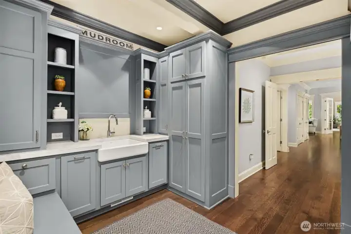 Perfectly positioned just steps from the primary bedroom closet, this highly functional mudroom doubles as a premium laundry hub. The beautifully organized space features extensive custom built-in cabinetry, a deep farmhouse utility sink, and a high-capacity washing machine and dryer, making daily chores effortless. Perfectly positioned just steps from the primary bedroom closet, this highly functional mudroom doubles as a premium laundry hub. The beautifully organized space features extensive custom built-in cabinetry, a deep farmhouse utility sink, and a high-capacity washing machine and dryer, making daily chores effortless.