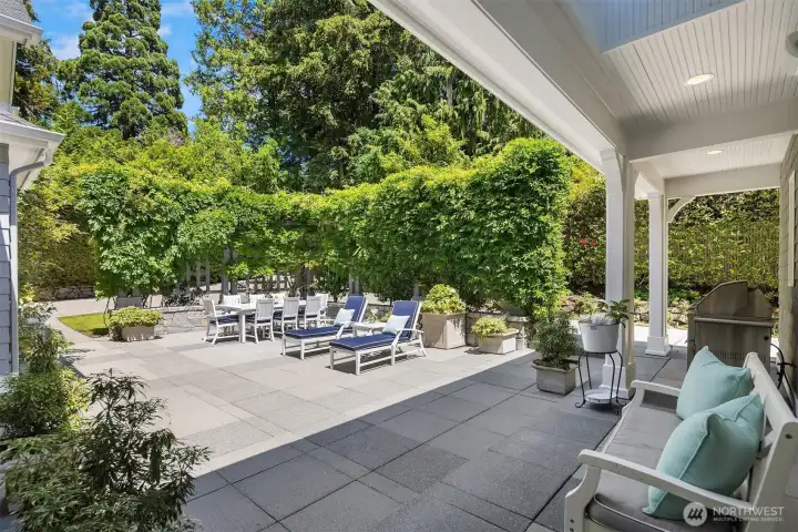 Offering a flawless transition for indoor-outdoor entertaining, this expansive stone patio boasts direct access to the chef’s kitchen. A beautiful covered architectural overhang provides the perfect, all-weather designated space for your BBQ setup, while the entire backyard is enveloped by lush, mature landscaping for ultimate privacy. Offering a flawless transition for indoor-outdoor entertaining, this expansive stone patio boasts direct access to the chef’s kitchen. A beautiful covered architectural overhang provides the perfect, all-weather designated space for your BBQ setup, while the entire backyard is enveloped by lush, mature landscaping for ultimate privacy.