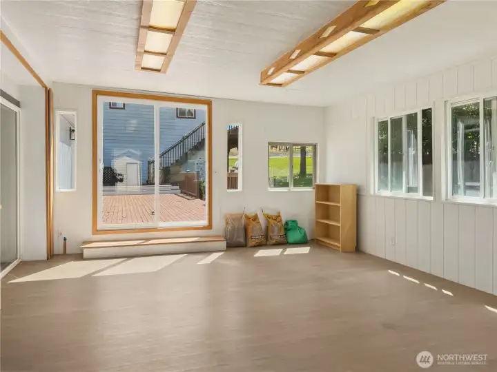 Sun room is entered from an exterior door on the west side, a slider from the kitchen, or from the expansive deck. Sun room is entered from an exterior door on the west side, a slider from the kitchen, or from the expansive deck.
