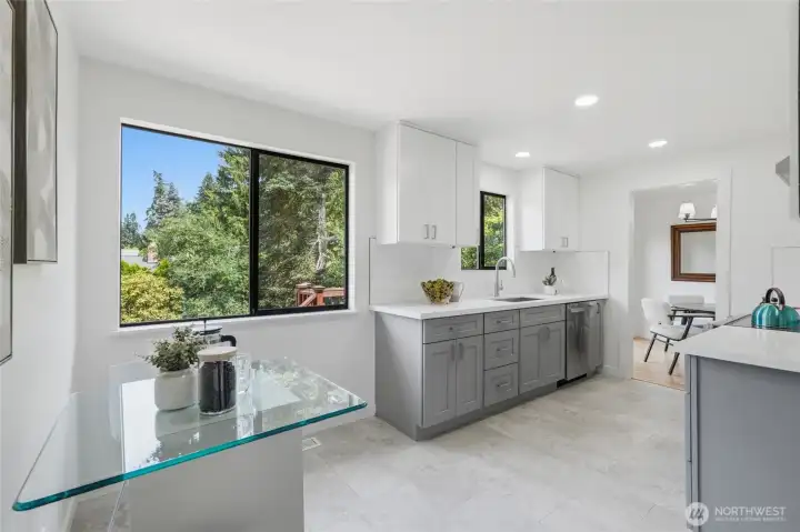The breakfast nook with large windows adjacent to the kitchen.