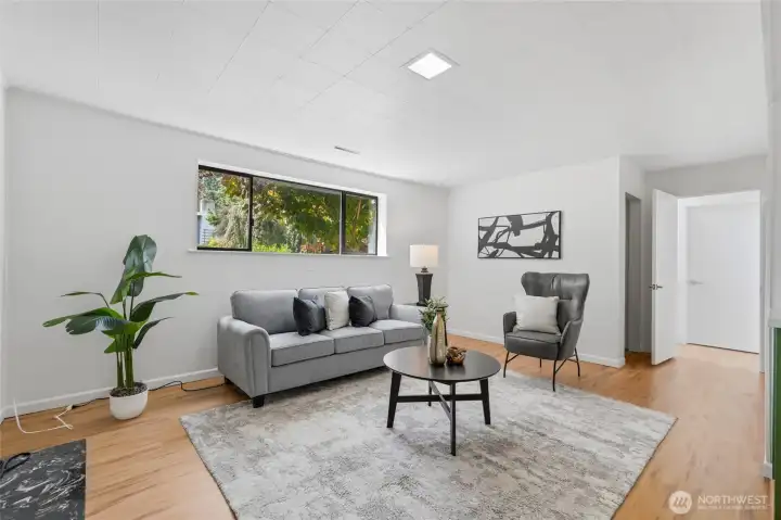 The lower level family room with a gas fireplace (to left of tile flooring, not visible in photo).