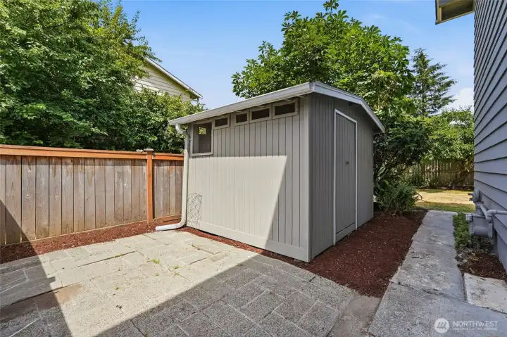 A large shed in the side yard provides ample extra storage.