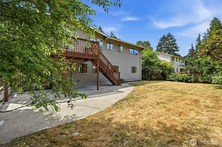 The backyard is fully-fenced, level, and generously sized with mature landscaping.