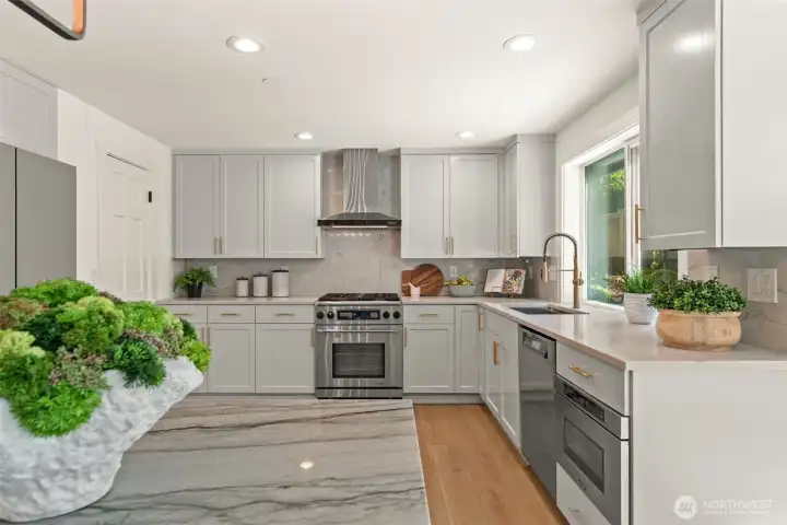 A designer chef's kitchen with refinished cabinetry and high-end SS appliances