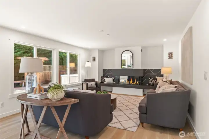 The main level family room offers a newly framed gas fireplace and large windows