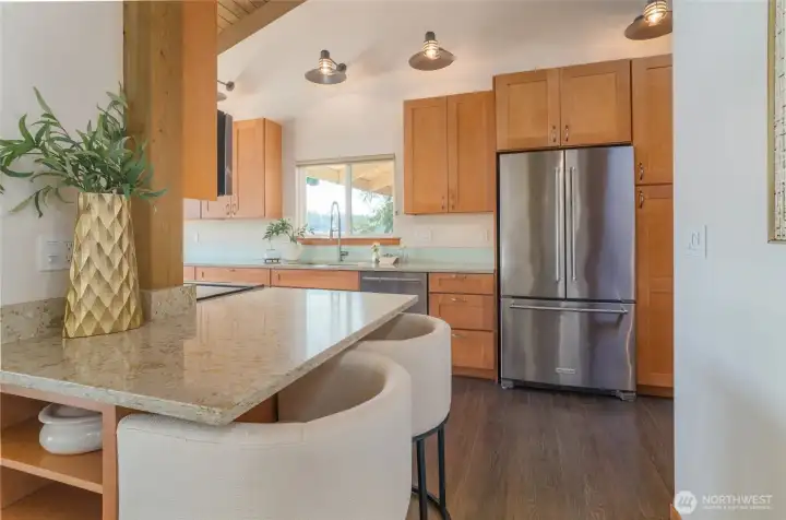 The beautiful kitchen is a delight, too.  A view of the bridge from your kitchen window, bar seating.....