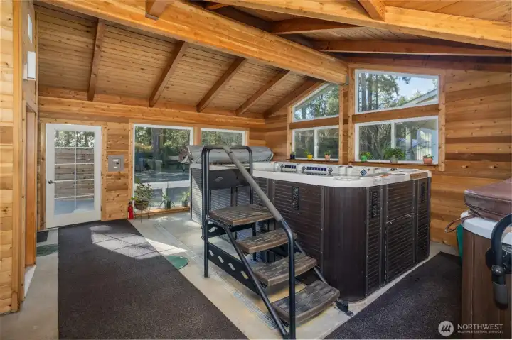 Welcome to the Natatorium!  This space is a converted attached garage that could be made back into a place to park.  It comes complete with a large swim spa & hot tub (to the far right)....