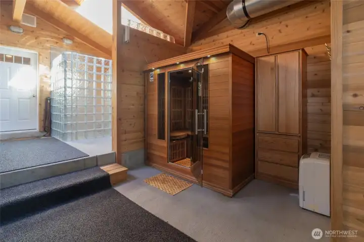 ....infrared sauna, and a glass block shower for rinsing (soap free). There is also a door to the right of the shower for direct beachside access. The door on the left is one of the two entrances to the guest house.  To the left of that door is access to the carport out in front of the house.