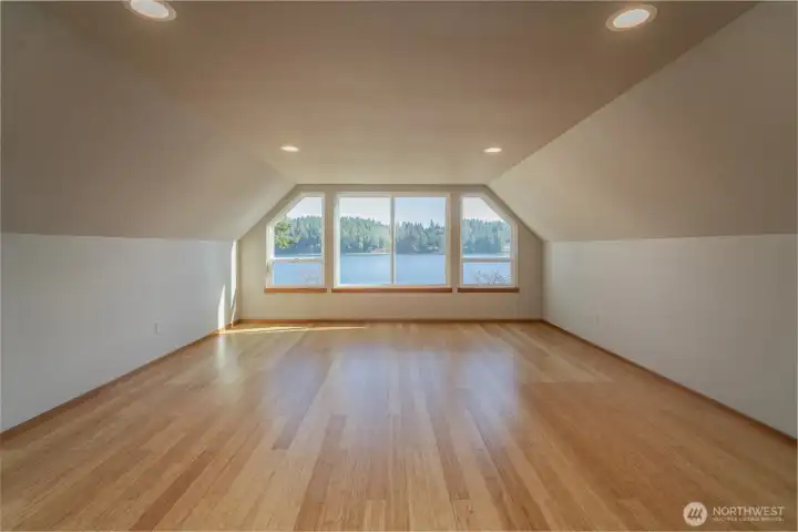 Upstairs is a HUGE bedroom with ensuite bath and walk in closet.The upstairs 3/4 bath with glass shower and walk-in closet to the far right.