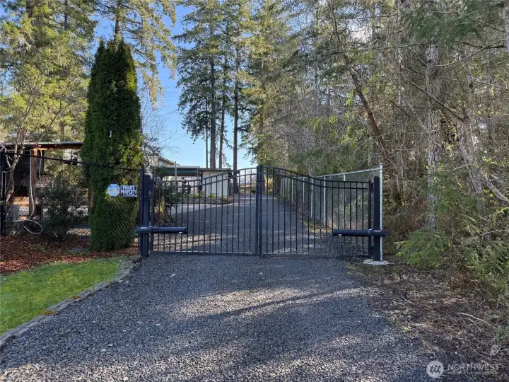Outside, as you enter the property, you will find beautiful grounds!  Before you get to the gate there is a large deer fenced garden abundant with fruit trees and berries.  There is also a garden shed for storage. A gated entry adds to the estate feel and offers added security.