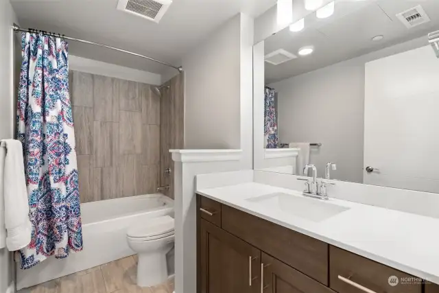 Main bathroom includes tile tub surround and Quartz counters