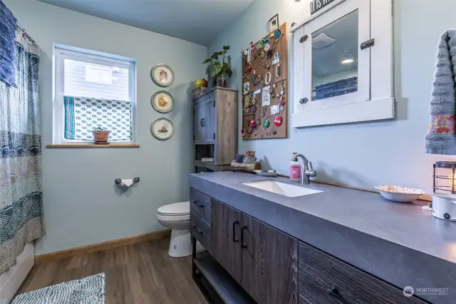 Roomy full bath with plenty of countertop space as well.