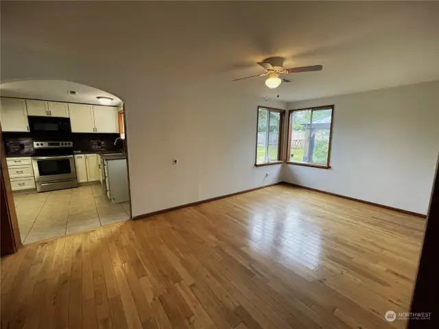 View from family room through your dining room with beautiful hardwood floor into the kitchen