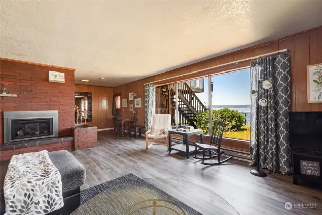 The downstairs gorgeous brick fireplace...there are some cherished mid-century features here! New floors throughout..