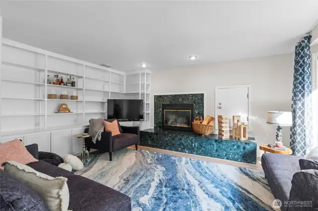 TV room with book shelves wood fireplace