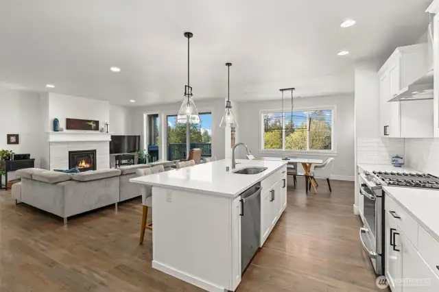 A generous island anchors the kitchen, offering seating, storage, and space to spread out while entertaining or cooking.