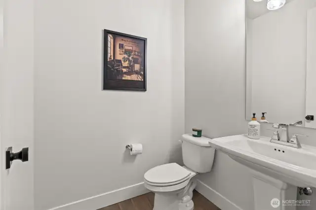 Conveniently located just off the entry, the stylish half bathroom is perfect for guests—offering both accessibility and privacy without stepping into the main living areas.