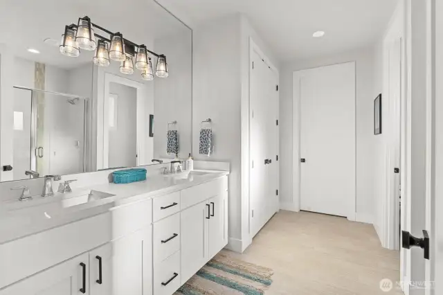 Enjoy the spa-like ensuite featuring a walk-in shower, dual vanities, and a generous walk-in closet designed for everyday luxury.