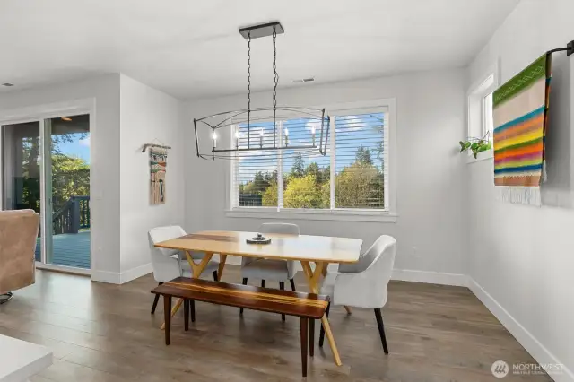 Soaked in natural light, the seamless flow from kitchen to dining to living room creates a welcoming and spacious feel.