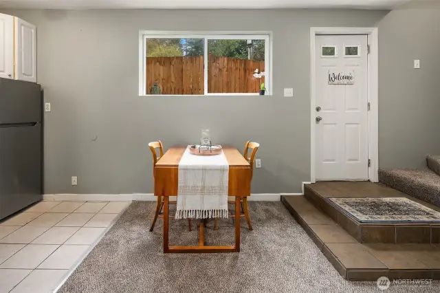 Dining area off of the kitchen providing easy access to upper half-story.