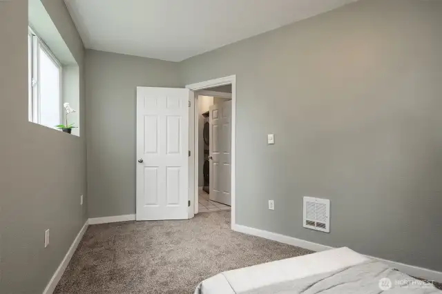 Main floor bedroom adjacent to full bathroom and living space.
