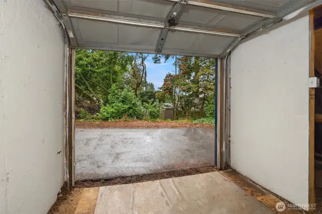 Single-car garage looking out to additional off-street parking spots.
