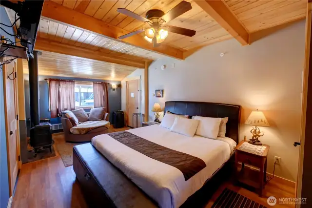 Unit 2 bedroom.  Snuggle up with your pet in a large cozy oversized chair in front of the fire.