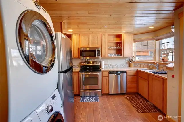 Shared full kitchen and laundry area accessed from outside the building for the use of all three Pet Suites renters.