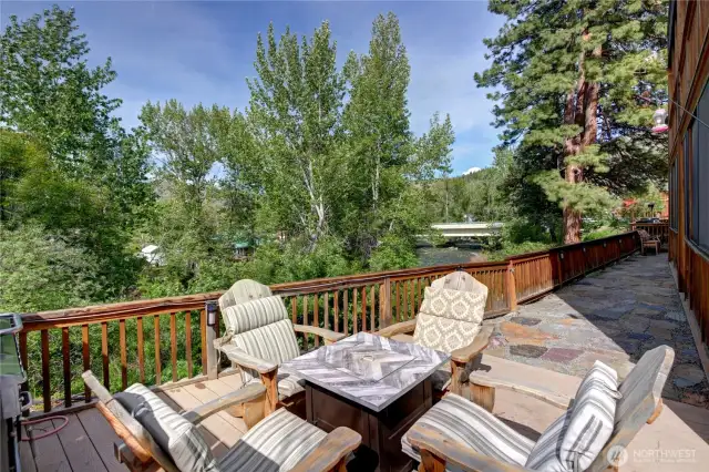 Communal outdoor propane fire tables with a view of the river.