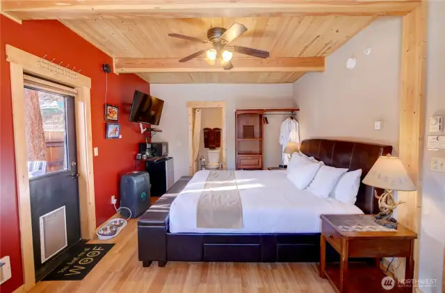 Unit 1 bedroom.  All units have dog bowls and beds, TV, internet, propane freestanding stoves, kitchenettes, ceiling fans, doggy doors to private yard areas, and load of ambiance.