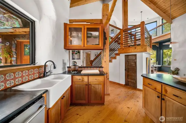 Check out those beautiful cabinets, and you get a glimpse of the stairwell to the master loft.