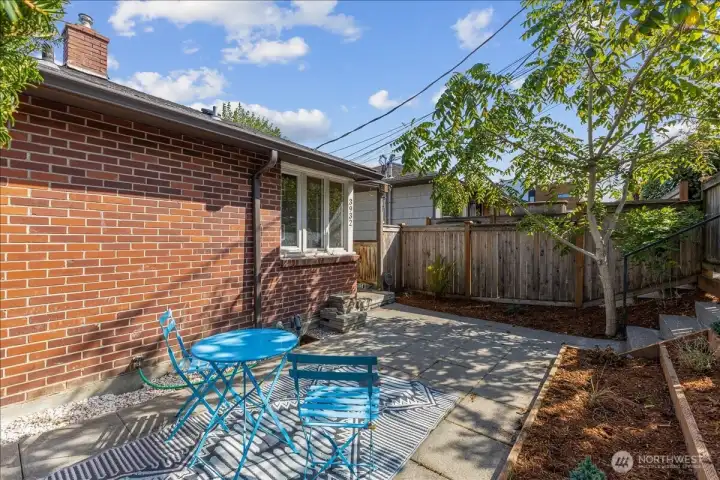 spacious patio with area for garden/flowers etc.
