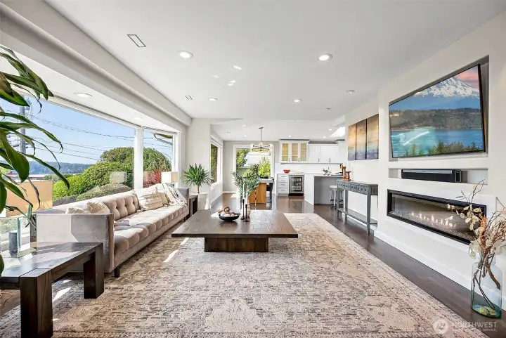 Enter into your beautifully updated living room with electric fireplace and sweeping Narrows, Puget Sound and Olympic Mountain views. The floors are original oak refinished to a modern design.