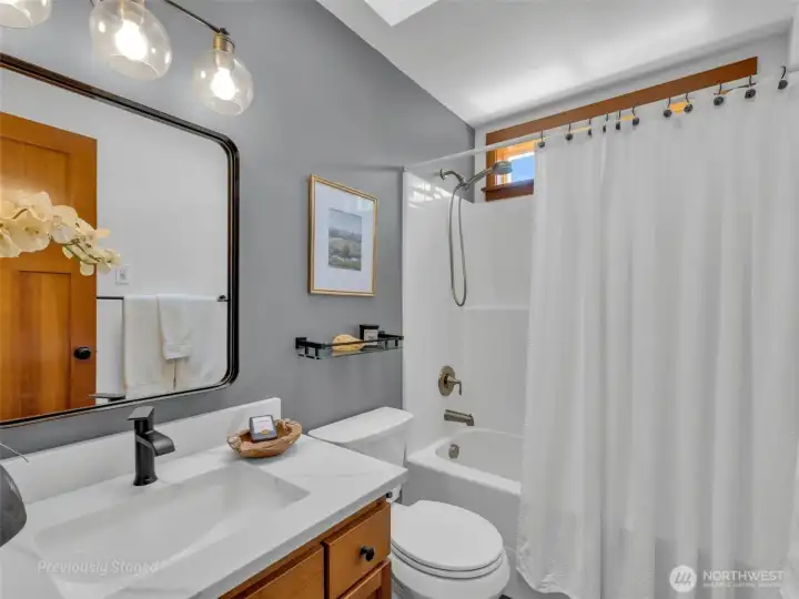 Hall bathroom has bath/shower combo and plenty of storage for all your bathroom needs