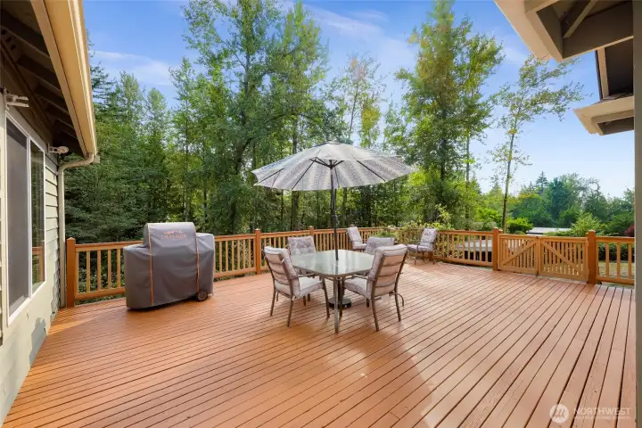 Large deck with plenty of room for BBQ's and summer entertaining.