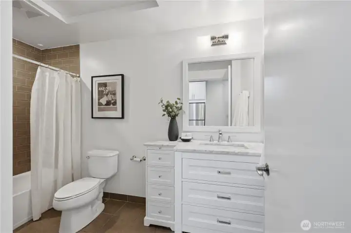 Lovely vanity with Marble Carrara countertops, tile bath & flooring!