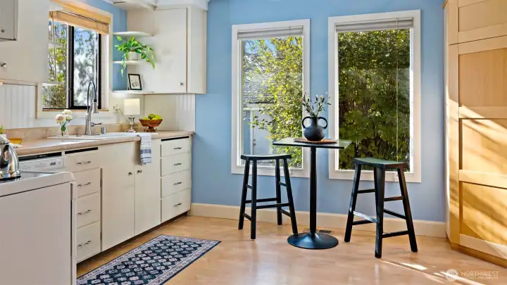 Sunlight pours through the windows, brightening every corner and making this space feel instantly welcoming. In the corner, another clever built-in pantry adds both charm and practical storage - perfect for keeping everything within easy reach.
