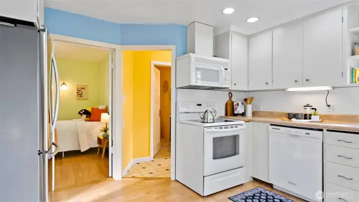 Here’s where the fridge fits perfectly, with a peek into the second bedroom just beyond. Down the hall, you’ll find the bathroom and laundry room - everything laid out with smart, easy flow.