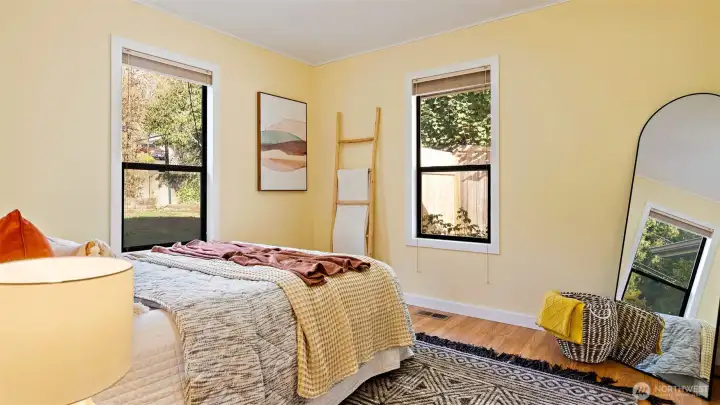 Bedroom one features double windows that let in plenty of natural light, and the soft yellow walls make the space feel cheerful and bright - an instant mood boost every time you walk in.