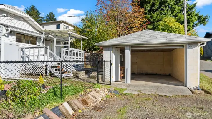 Here’s a great look at the four-foot black chain-link fence surrounding the backyard - it defines the space beautifully while keeping things open and bright. The entire property is fully fenced, perfect for gardening, pets, or simply enjoying a sense of peace outdoors.