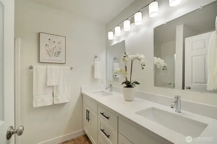 Primary en suite bathroom with double vanities