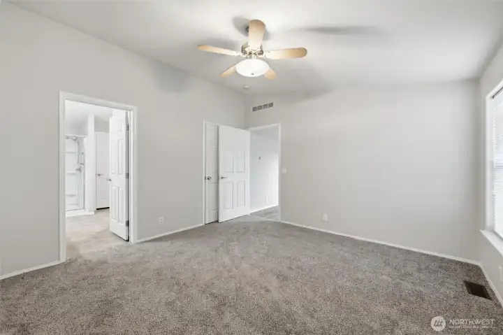 Primary ensuite with walk in shower.  Door in corner leads to walk in closet.