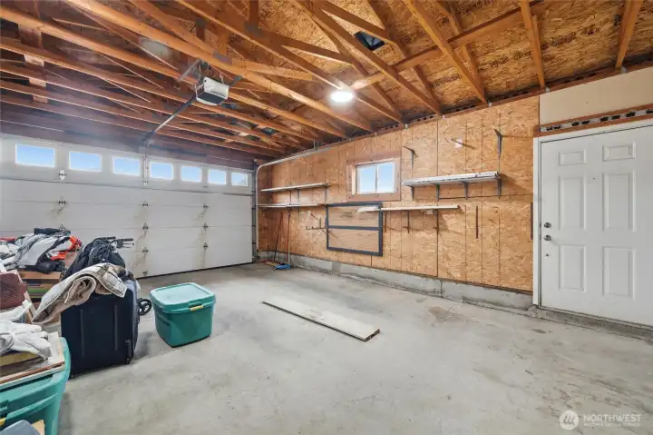 Attached oversized two car garage with man door to front yard.